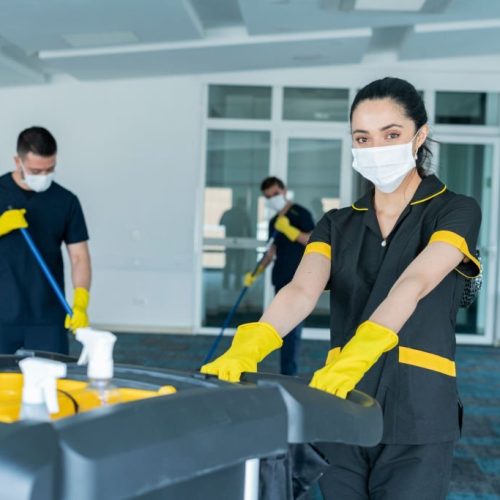 Cleaning staff composed of men and women of Latino ethnicity between the ages of 20-30 are cleaning the building to avoid the risk of contagion by COVID-19